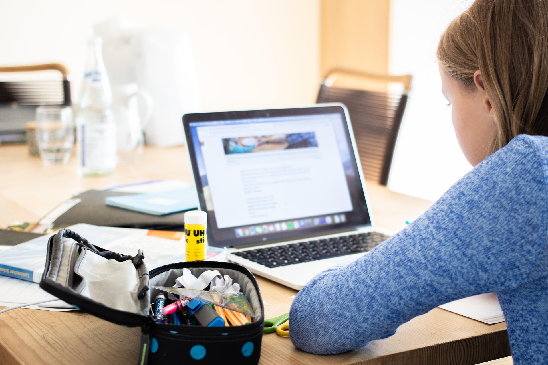 A student working through a lesson on her laptop at home